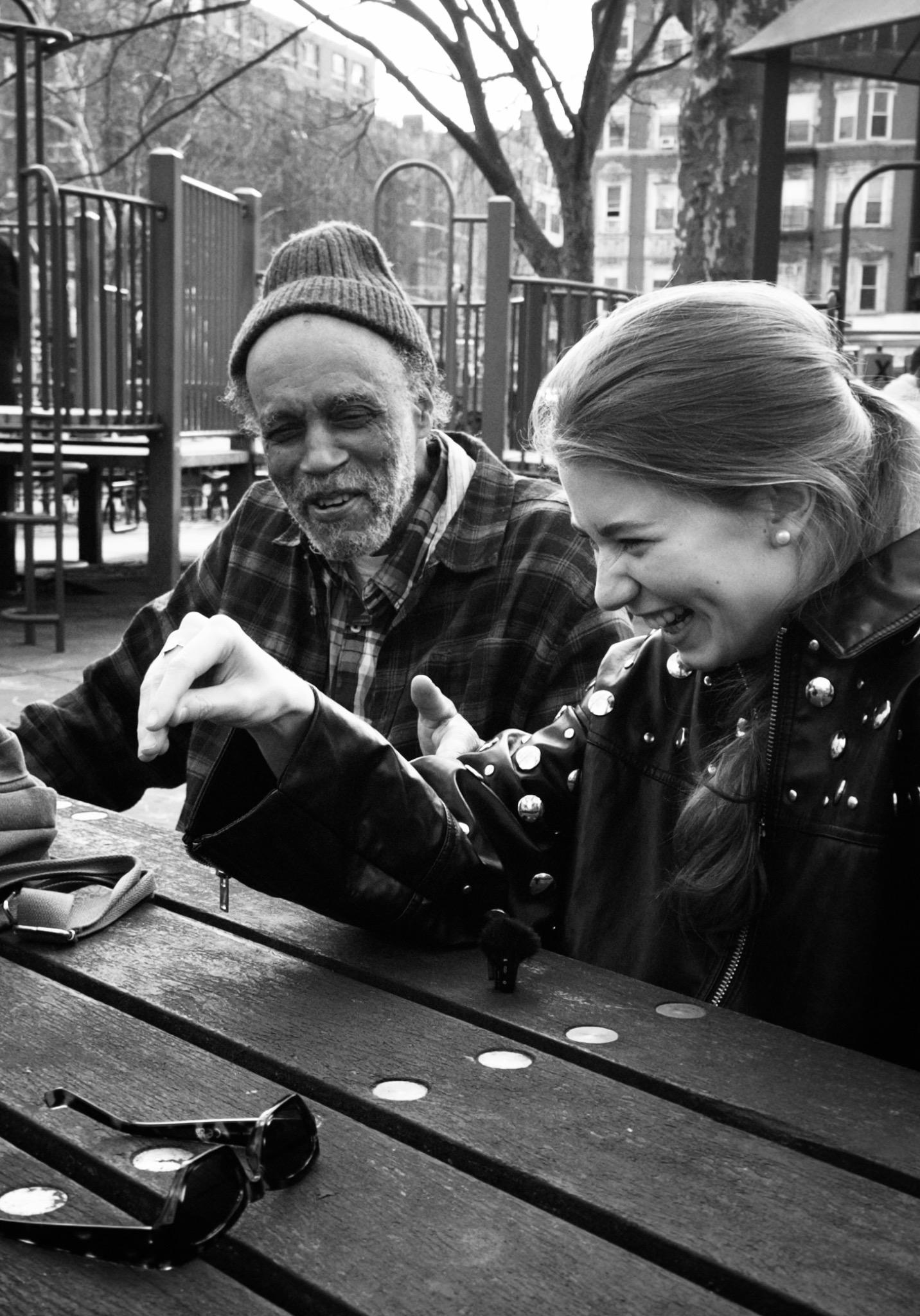 A young artist sharing a candid moment with an older musician in New York City